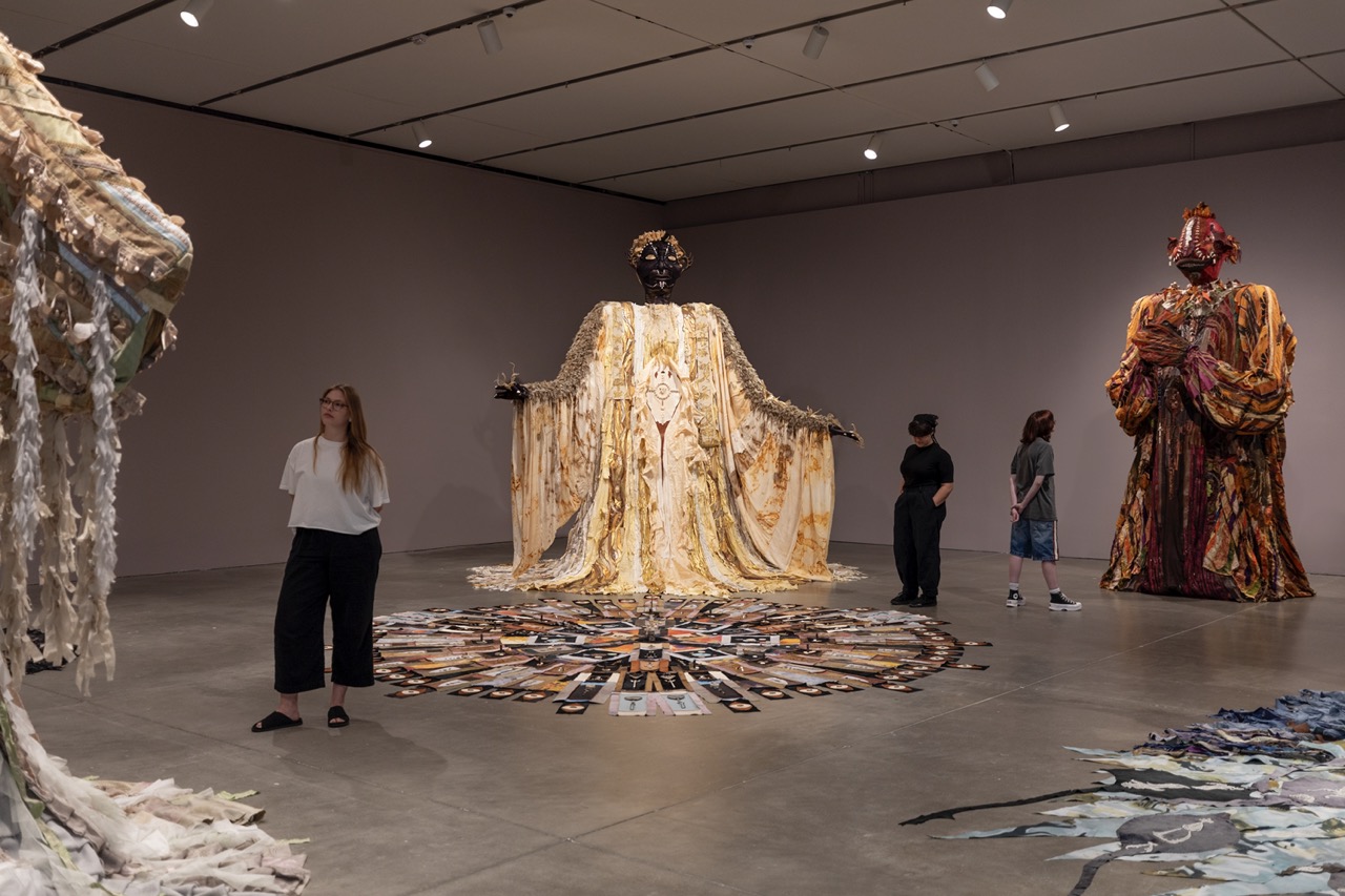 Tau Lewis Walks Amongst Giants